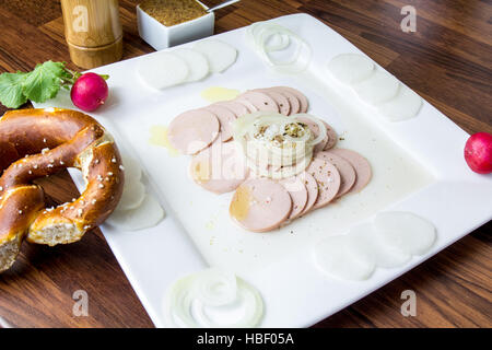 Bavarian sausage salad with a pretzel Stock Photo