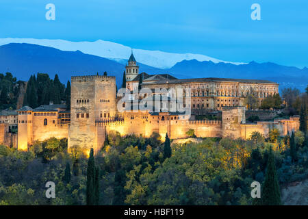 Alhambra - medieval Moorish fortress surrounded by yellow autumn trees illuminated in the evening, Granada, Andalusia, Spain Stock Photo