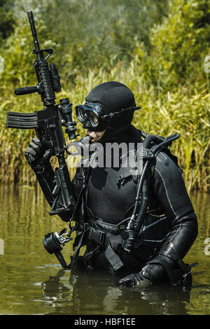 U.S. Navy SEAL combat diver prepares for HALO jump operations from a ...