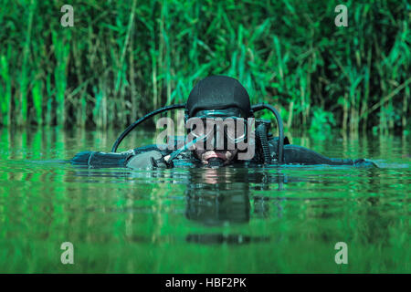 U.S. Navy SEAL combat diver prepares for HALO jump operations from a C ...