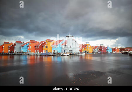 colorful buildings on water during storm Stock Photo