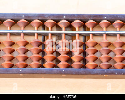 Japanese abacus called Soroban on wooden table Stock Photo