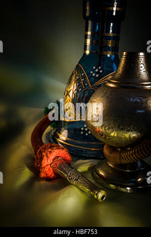 Still Life with Water Pipe. Nargile-Hookah with engraved equipment on dark environment Stock Photo