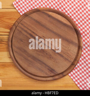Pizza board with napkin on wooden table. Top view mockup Stock Photo