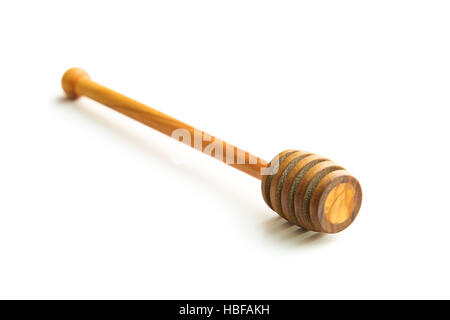 Wooden honey dipper made from olive wood. Isolated on white background. Stock Photo