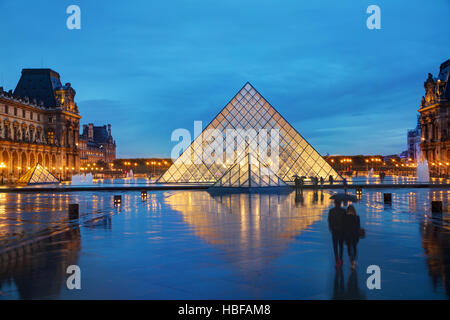 PARIS - NOVEMBER 4: The Louvre Pyramid on November 4, 2016 in Paris, France. It serves as the main entrance to the Louvre Museum. Completed in 1989 Stock Photo