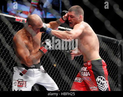 Nick Diaz, right, punches BJ Penn during UFC 137 at the Mandalay Events ...