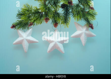 three toy star on spruce branch Stock Photo