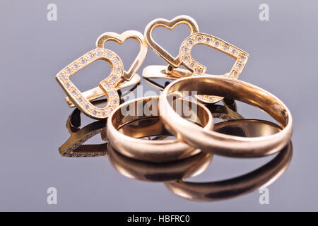 gold wedding rings and earrings Stock Photo