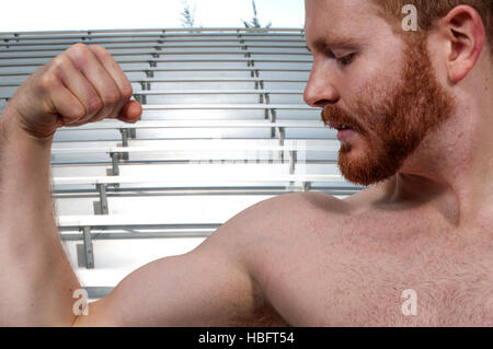 Man Flexing Muscles Stock Photo