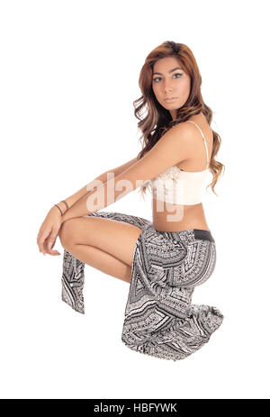 Lovely young woman crouching on floor. Stock Photo