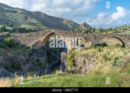 Medieval bridge over River Simeto, Bridge of Saracens, Ponte dei Saraceni, western side of Etna, Adrano, Sicily, Italy Stock Photo