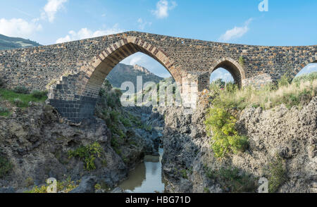 Medieval bridge over River Simeto, Bridge of Saracens, Ponte dei Saraceni, western side of Etna, Adrano, Sicily, Italy Stock Photo