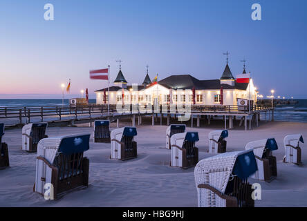 Beach chairs, Ahlbeck seaside resort pier at dusk, Ahlbeck, Heringsdorf, Usedom, Baltic Sea, Mecklenburg-Western Pomerania Stock Photo