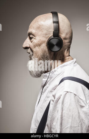 elderly bald head man with headphones Stock Photo