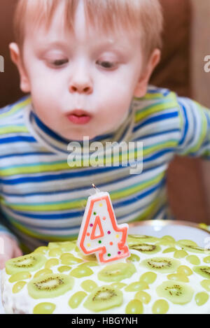 boy blows out the candles Stock Photo