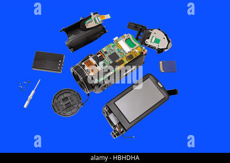 Disassembled compact camcorder. Close-up. Isolated on a blue background. Stock Photo