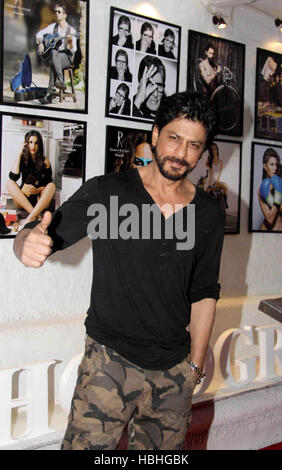 Shah Rukh Khan, Indian Bollywood actor with framed prints of calendar of fashion photographer Dabboo Ratnani in Mumbai India Stock Photo