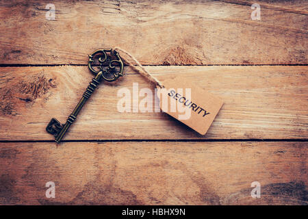 Business concept - Old key vintage on wood with tag security. Stock Photo
