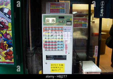 Vending machine at front of Noodle ramen shop for people buy noodles at shinjuku city on October 20, 2016 in Tokyo, Japan.