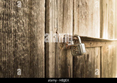 Metal lock on old barn Stock Photo