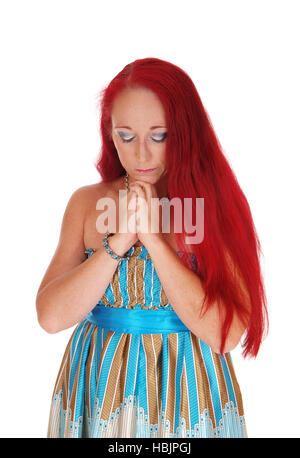 Woman praying with hands folded. Stock Photo