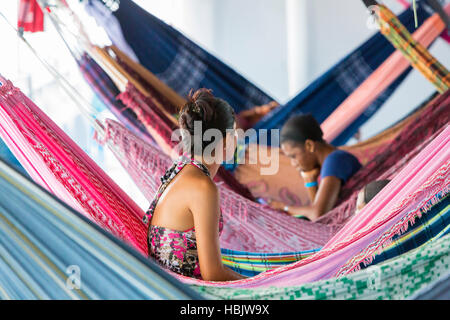 People resting in hammocks on passenger boat deck, Brazil Stock Photo