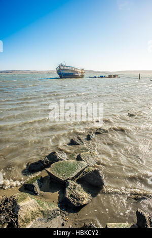 Old Wooden Boat in Bay. Stock Photo