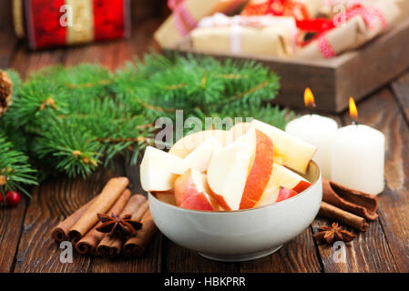 apples with cinnamon in the bowl and on a table Stock Photo