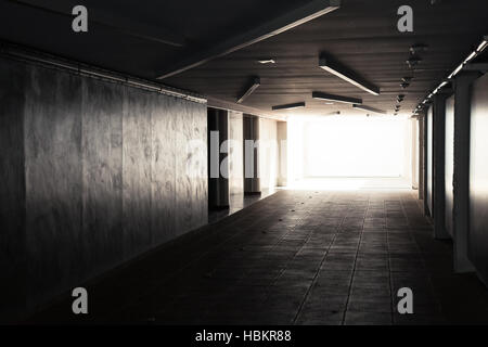 Empty underpass corridor. Dark abstract underground tunnel interior with glowing end Stock Photo