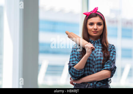 Woman with rolling pin in the kitchen Stock Photo