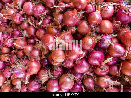 Heap of red onions on market Stock Photo