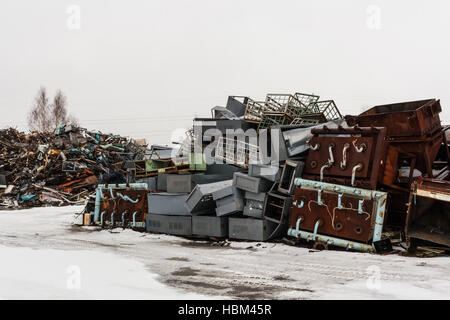 Two big scrap metal heap on snow in winter. Stock Photo