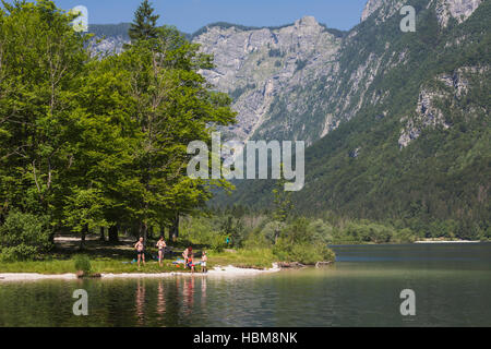 Triglav National Park, Upper Carniola, Slovenia.  Lake Bohinj.  Bathers enjoying a dip in the lake. Stock Photo