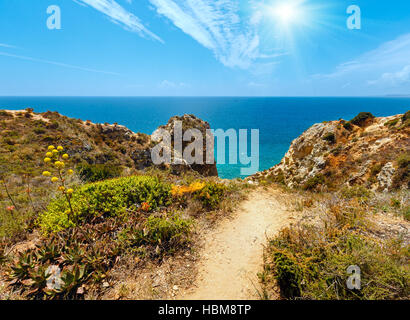 Sunshine above Atlantic rocky coastline (Algarve, Portugal). Stock Photo