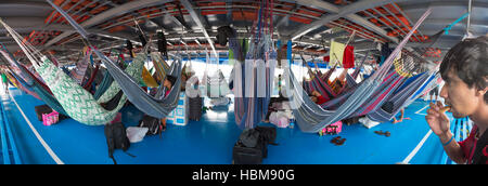 People resting in hammocks on passenger boat deck, Brazil Stock Photo