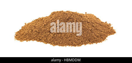 A small serving of carob powder isolated on a white background. Stock Photo