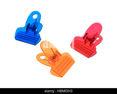 Three colorful plastic clips isolated on a white background. Stock Photo