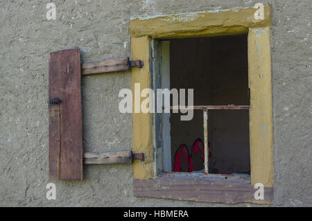 Old open and broken window on wall Stock Photo