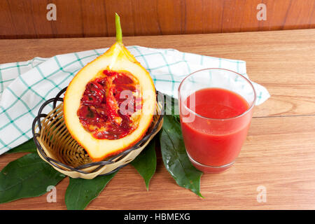 Baby Jack fruit and juice (Or Cochinchin Gourd, Spiny Bitter Gourd, Sweet Gourd, Momordica cochinchinensis, Momordica cochinchinensis (Lour) Spreng.) Stock Photo