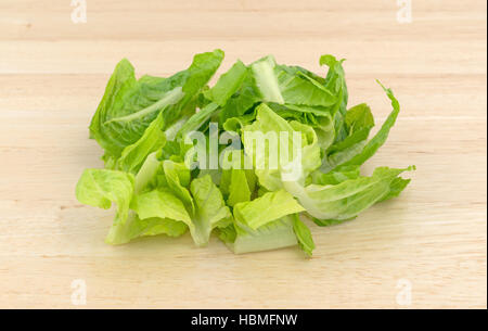 Romaine lettuce that has been sliced on a wood cutting board. Stock Photo