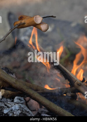 Sausages fried over open fire Stock Photo