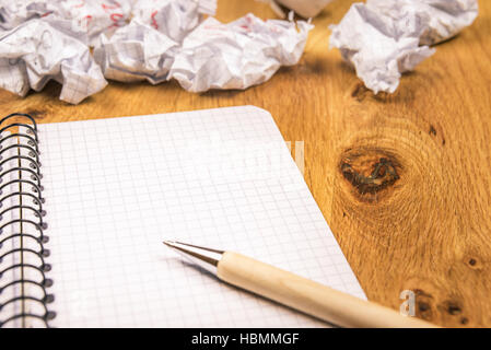 Blank graph notebook and crumpled drafts Stock Photo