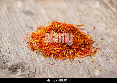 pile of saffron on the old wooden background Stock Photo