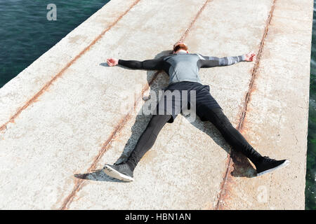 Man lying on the dock. above view Stock Photo
