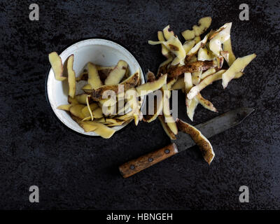 Top view of potato peelings on the stone table Stock Photo