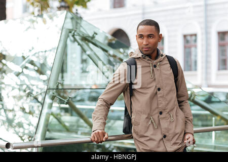 Picture of young african man standing in the street and look aside. Stock Photo