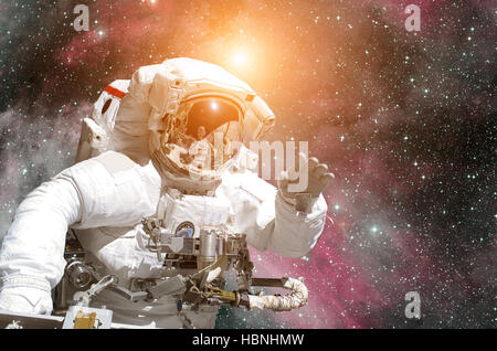 Astronaut in outer space. Nebula on the background. Elements of this image furnished by NASA. Stock Photo