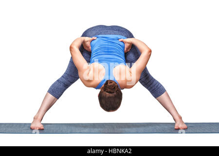 Sporty fit woman doing yoga asana Prasarita padottanasana B Stock Photo