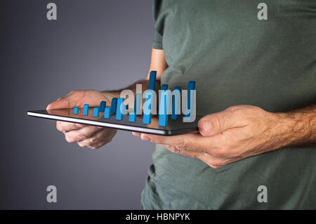 Businessman analyzing financial statistics displayed on the tablet screen. Selective focus. Stock Photo